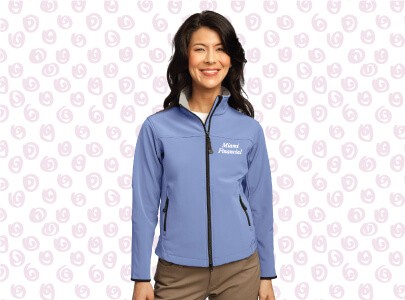 Woman wearing a purple, light weight, zippered jacket decorated with Miami Financial logo for those cool southern Florida evenings in the winter.